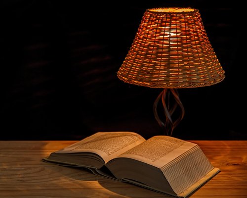 Cozy reading corner with warm lamp light