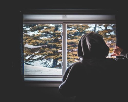Person resting eyes by looking out the window