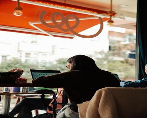 Adjusting brightness on a laptop in a cafe